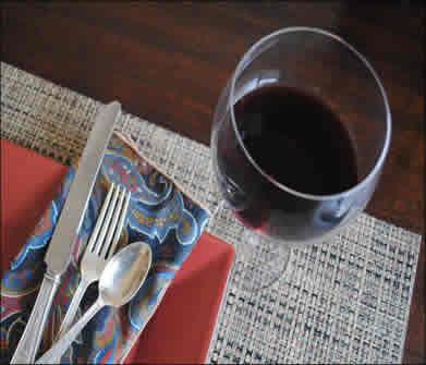 red wine glass with red dinner plate